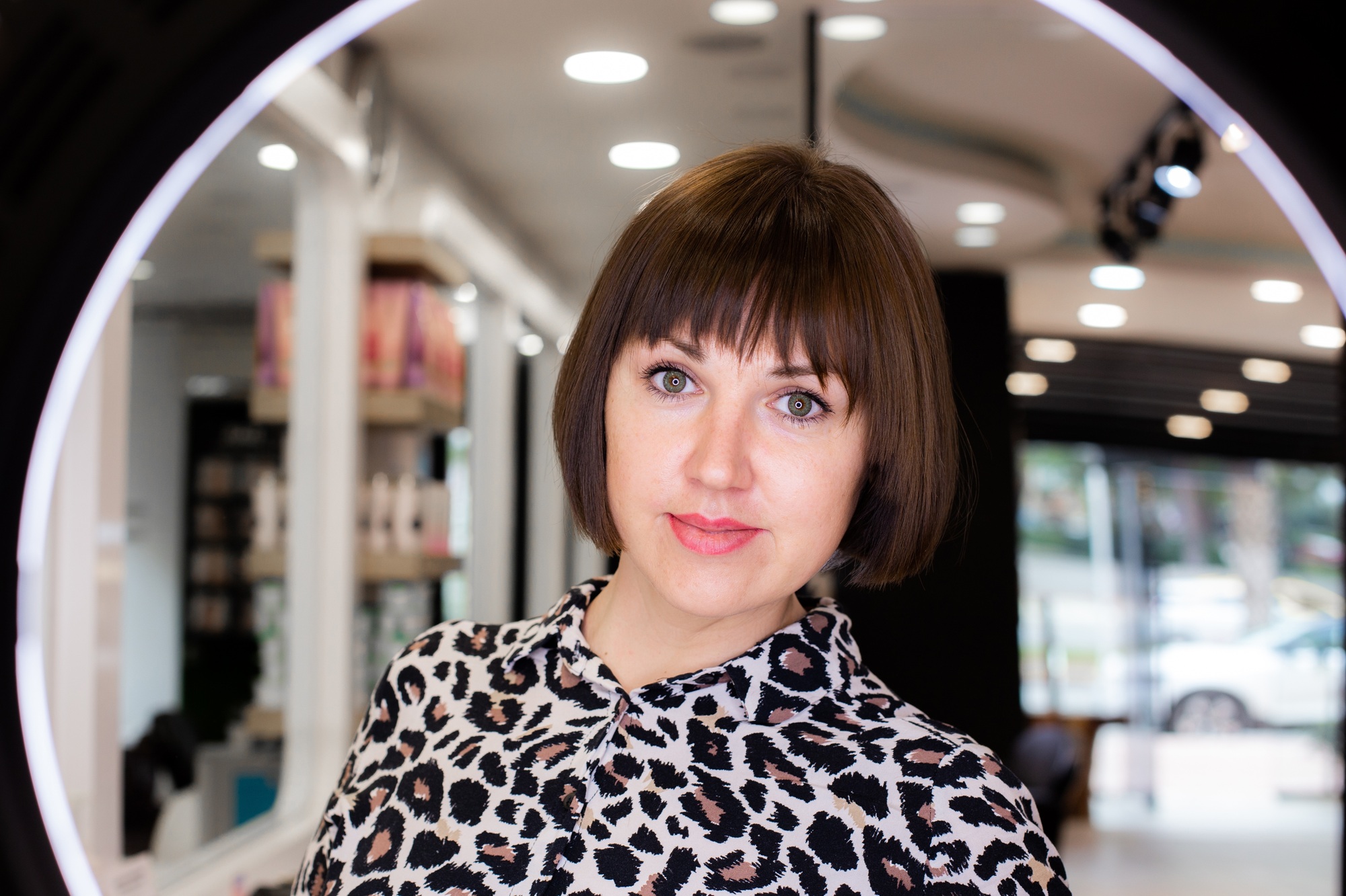 Beautiful woman in hair dresser salon after her haircut